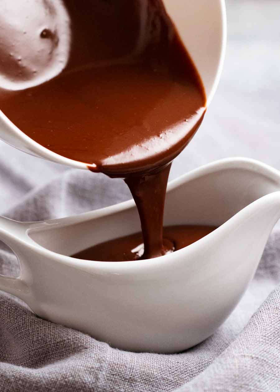Pouring chocolate sauce into jug for Hot chocolate fudge cake